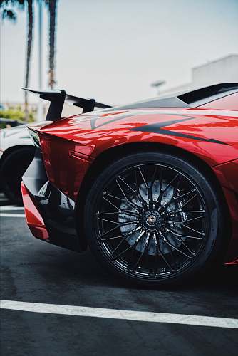 sports car black and red Lamborghini Aventador SV rear left side wheel
